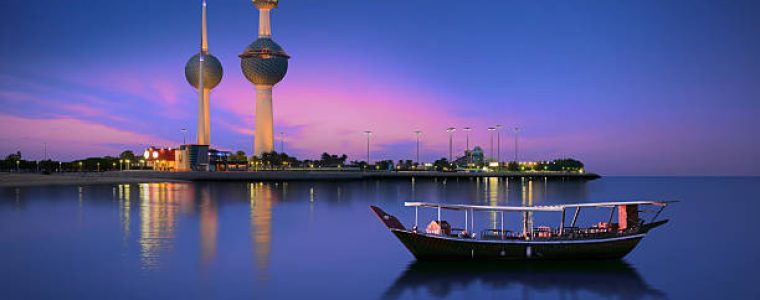 Arabian passenger boat during blue hour next to kuwait tower